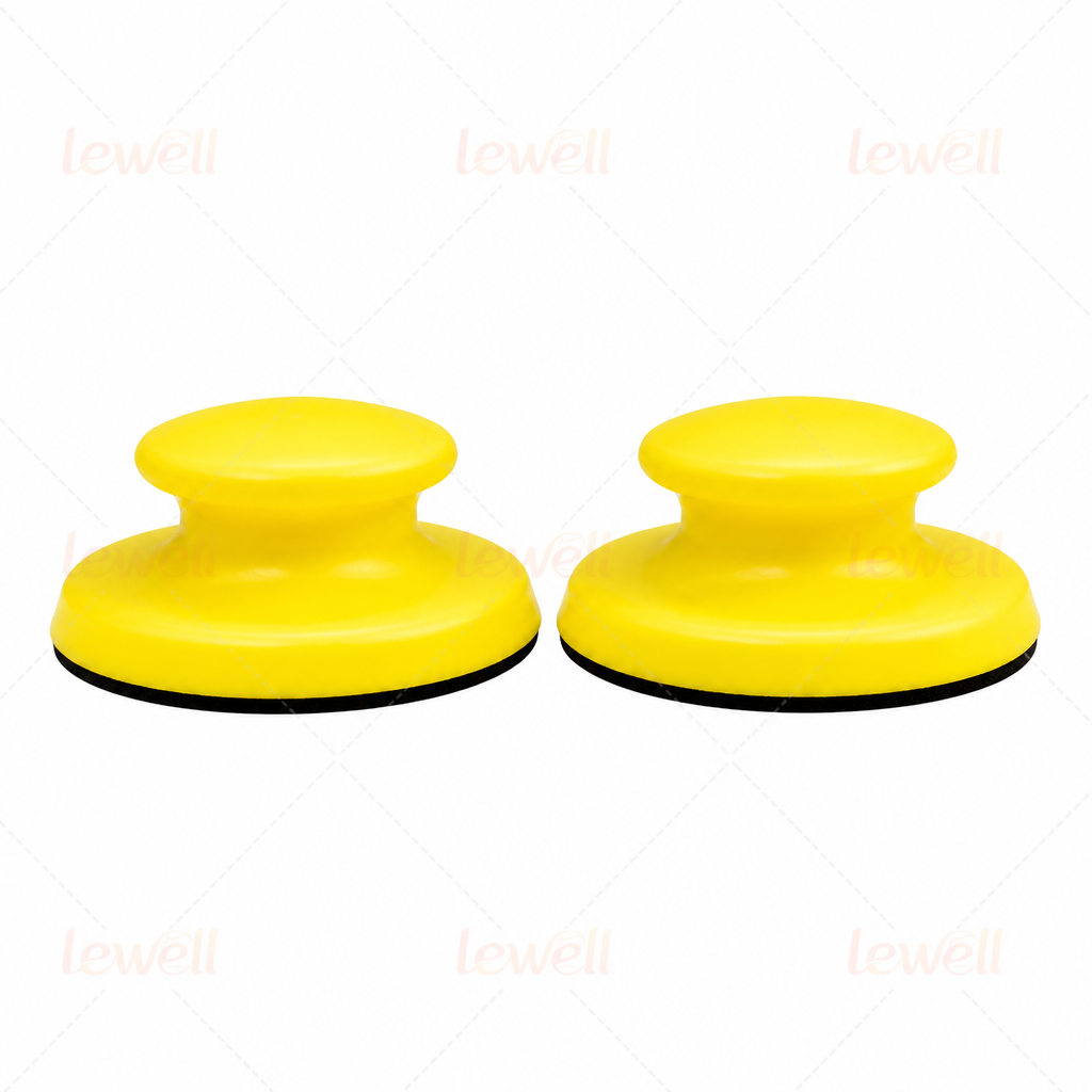 Two yellow handheld sanding blocks with domed foam tops and black bottoms