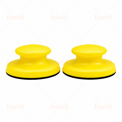 Two yellow handheld sanding blocks with domed foam tops and black bottoms