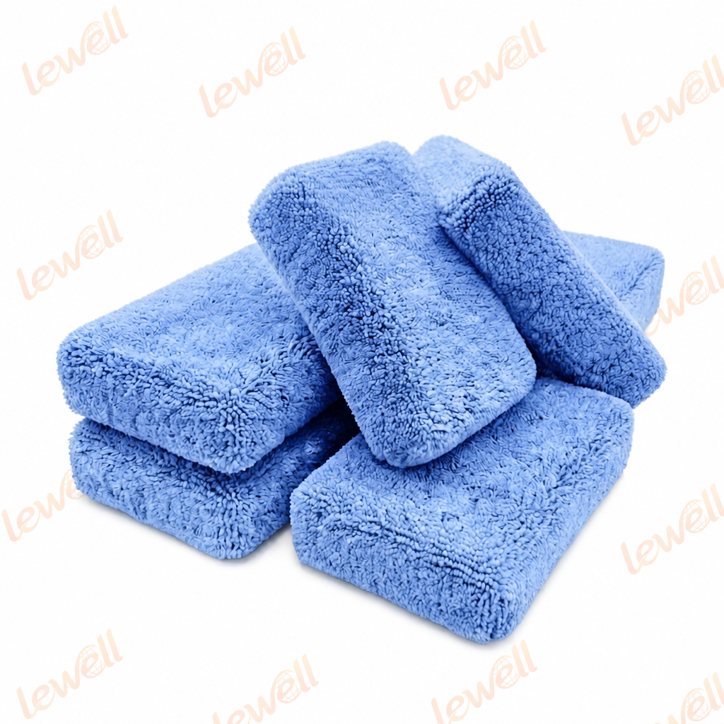 Blue microfiber applicator sponge blocks stacked, soft textured surface