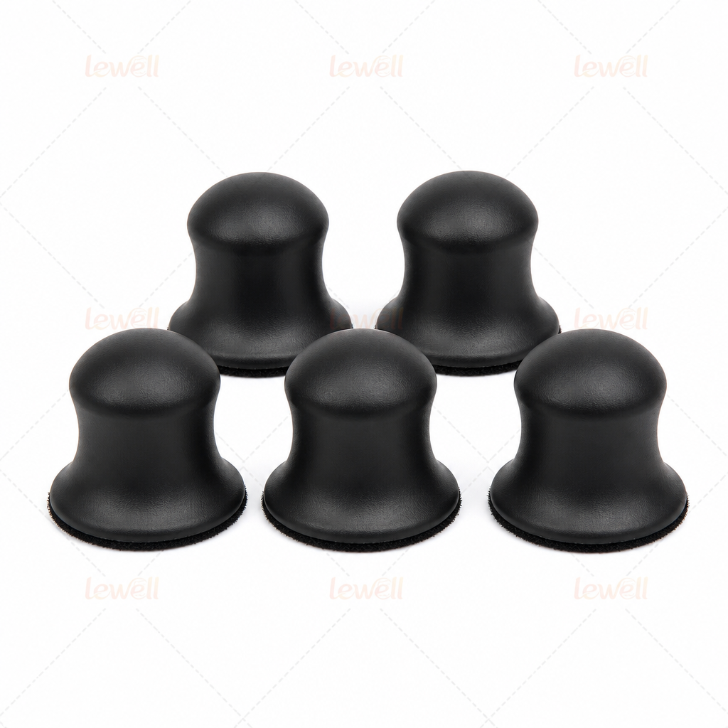 Set of black hook-and-loop sanding pads with domed foam tops