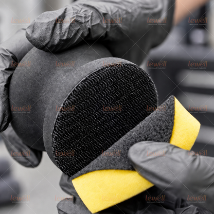 Black EVA sanding block showing textured hook-and-loop side and cushioned body.