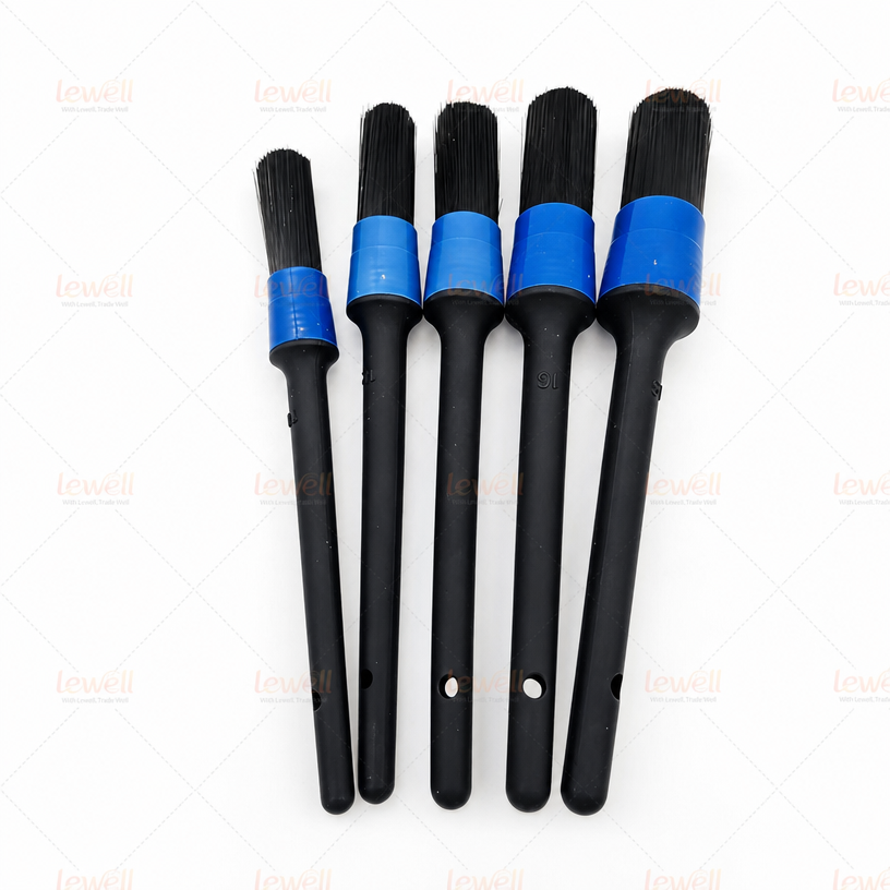Car detailing brush set with black bristles, black handles, and blue end caps