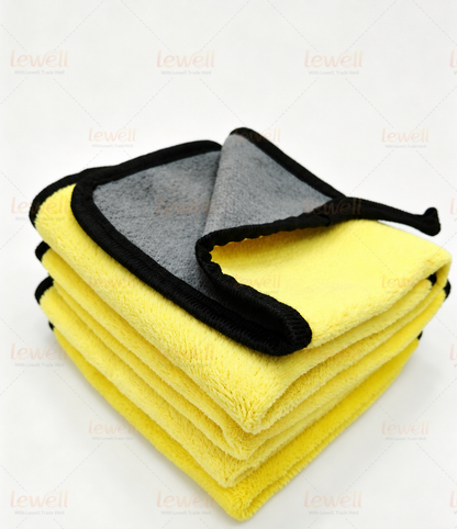 Grey and yellow coral fleece detailing towels with black edging, folded stack