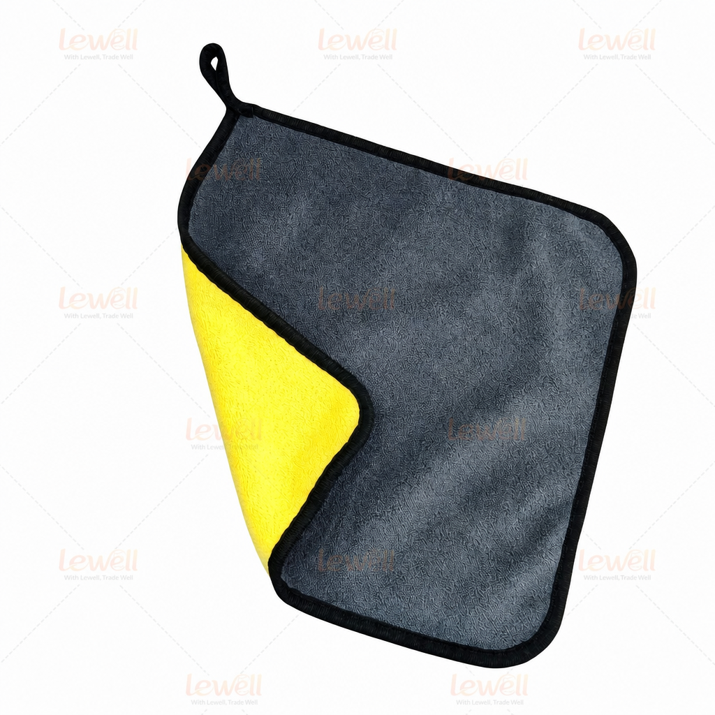 Single grey and yellow coral fleece detailing towel with black border and hanging loop