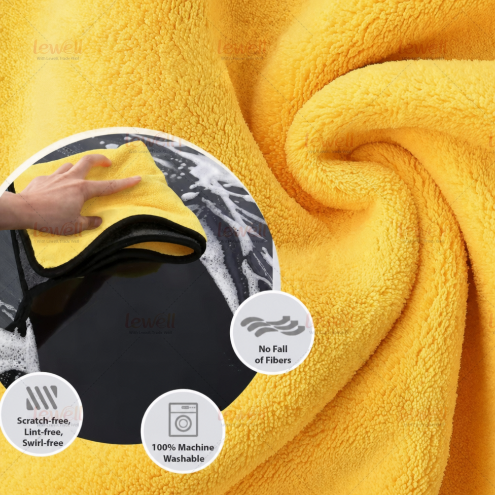 Close-up of yellow coral fleece towel with black-edged fold and plush texture